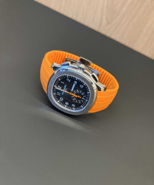 Patek Philippe Aquanaut cronógrafo 5968A con esfera gris y correa naranja sobre fondo liso